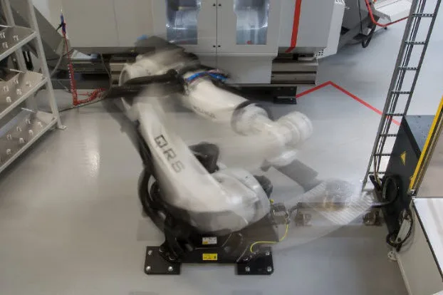 Industrial robot in motion during a magnesium die casting production process, showcasing advanced automation technology at Formkon.
